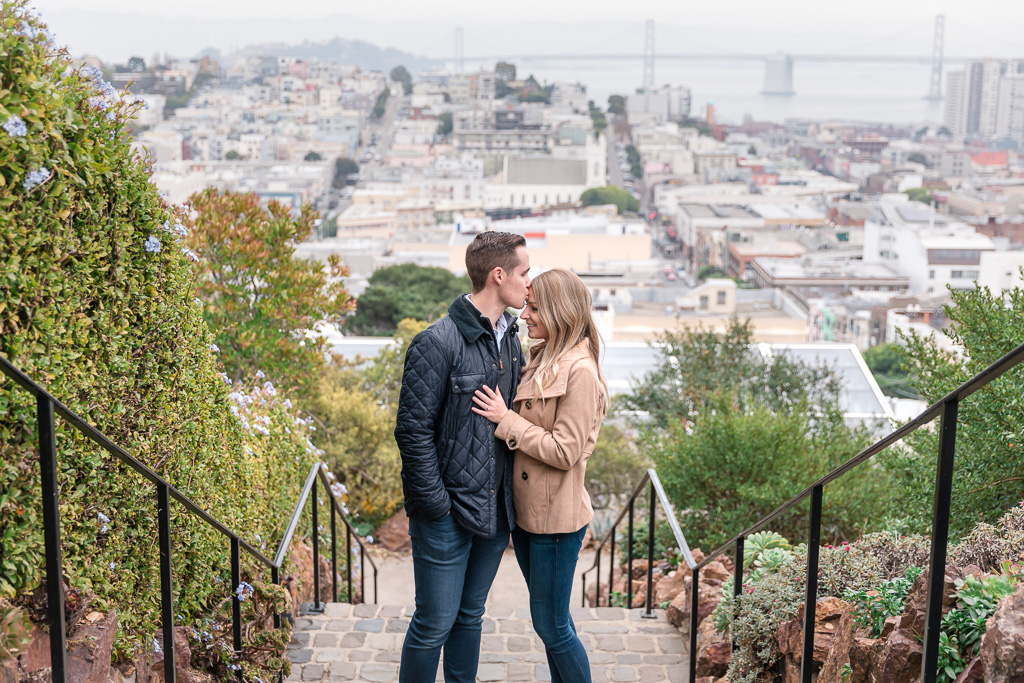 San Francisco staircase engagement photos with city skyline background