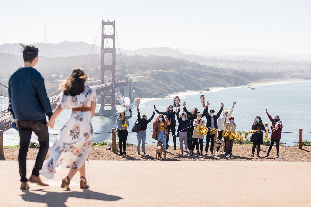 friends gathered in front of Golden Gate Bridge to congratulate our proposal couple