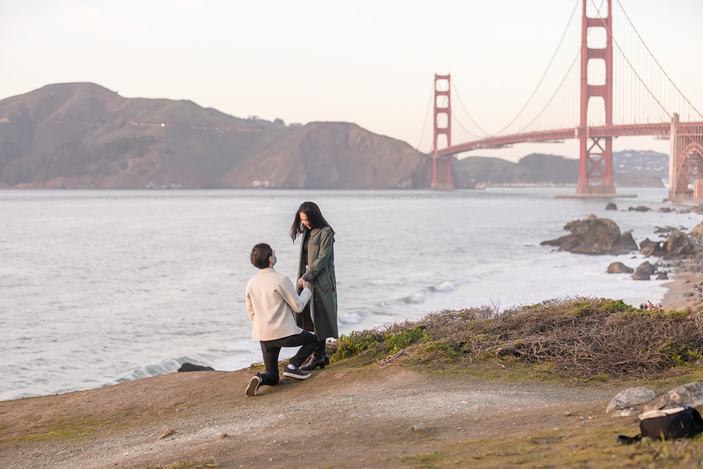 surprise engagement with San Francisco coastside view of the Golden Gate Bridge