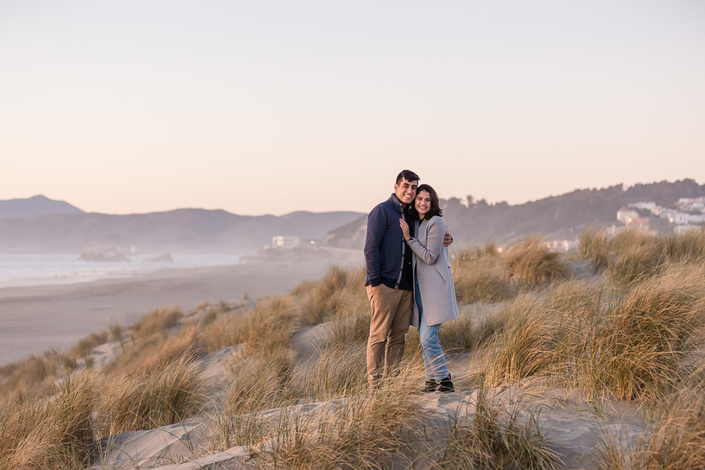 engagement photo right after their proposal by the beach with Cliff House in the background