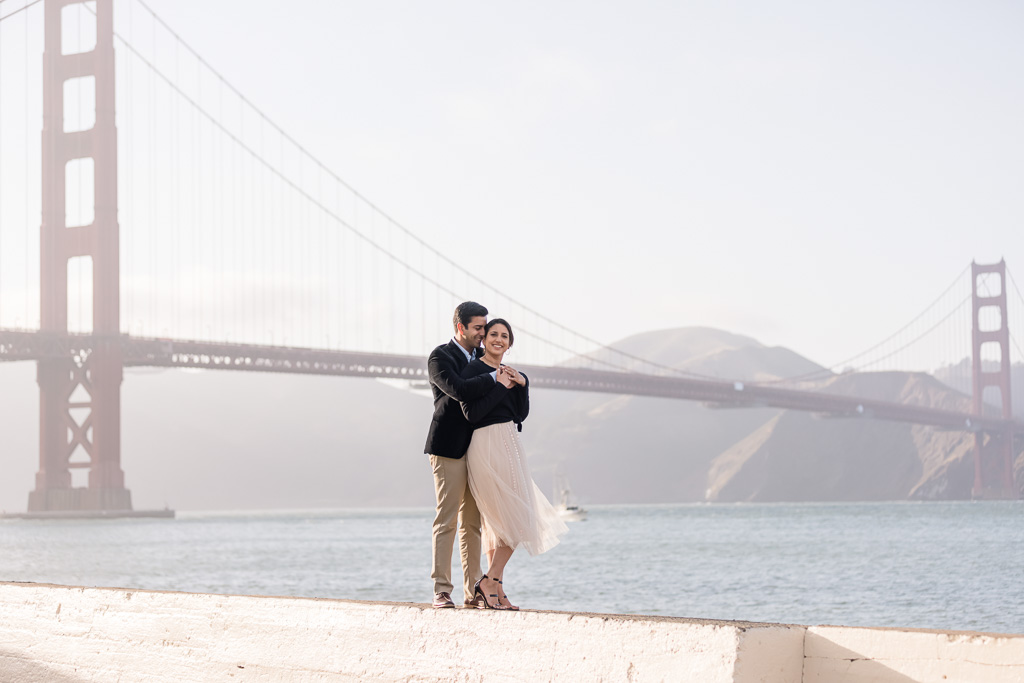 couple standing in front of Golden Gate Bridge