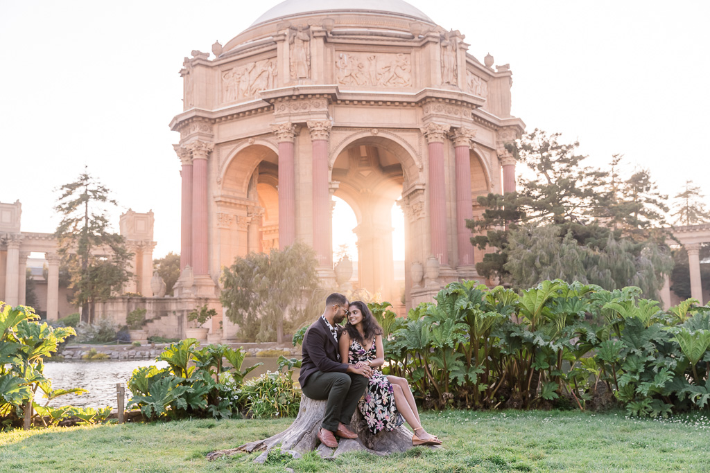 couple portrait in front of a glowing golden Palace of Fine Arts