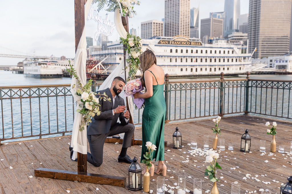 surprise engagement in front of San Francisco Belle