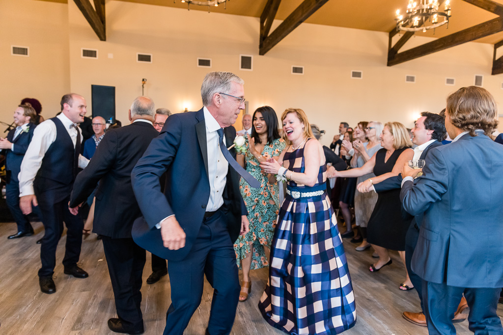 groom’s parents dancing and partying at wedding