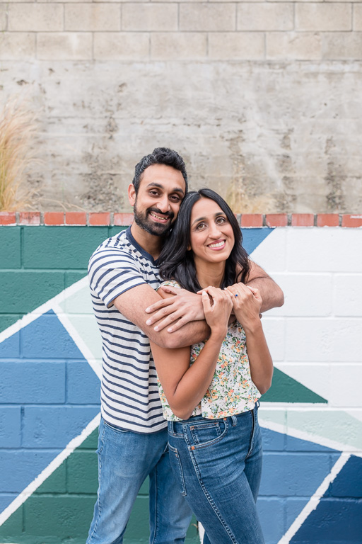 engagement photos in front of painted wall