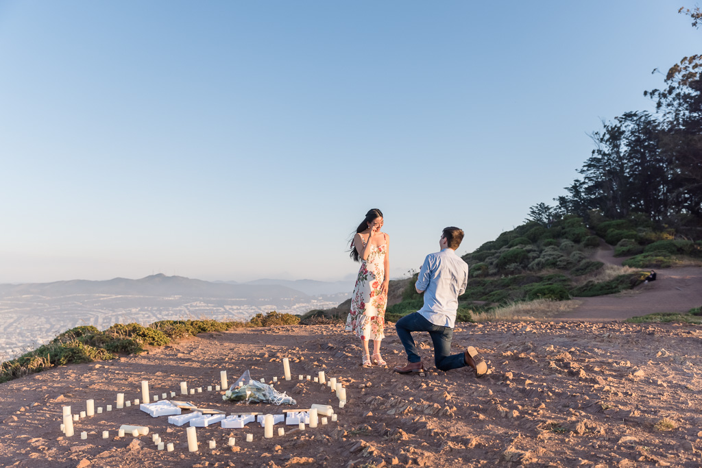 surprise proposal at a San Francisco mountain with a heart-shaped candle setup