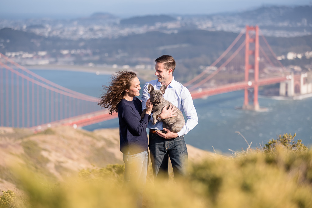 Little Frenchie and his parents posing in front of Golden Gate Bridge