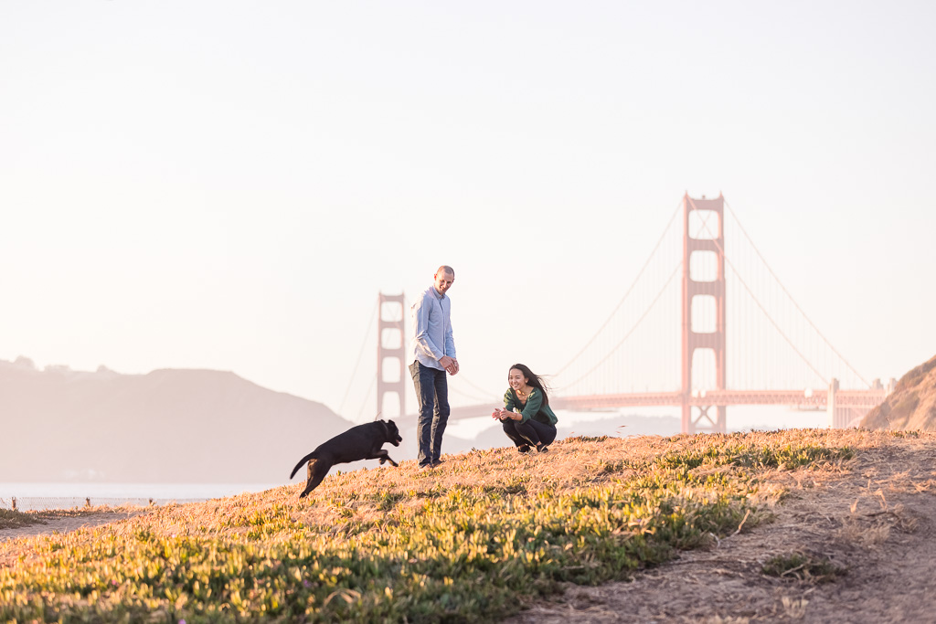 photo of couple and dog in front of Golden Gate Bridge