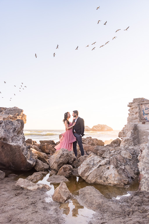 engagement photo on the Sutro Baths ruined wall opening at sunset