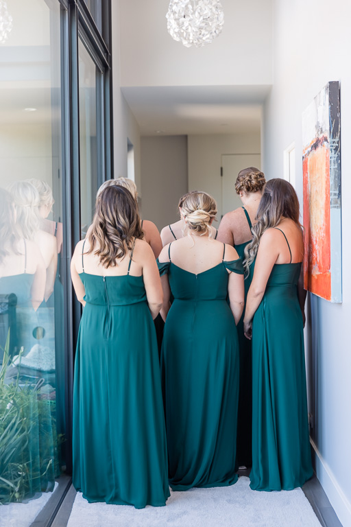 bridesmaids wearing green dresses in hallway