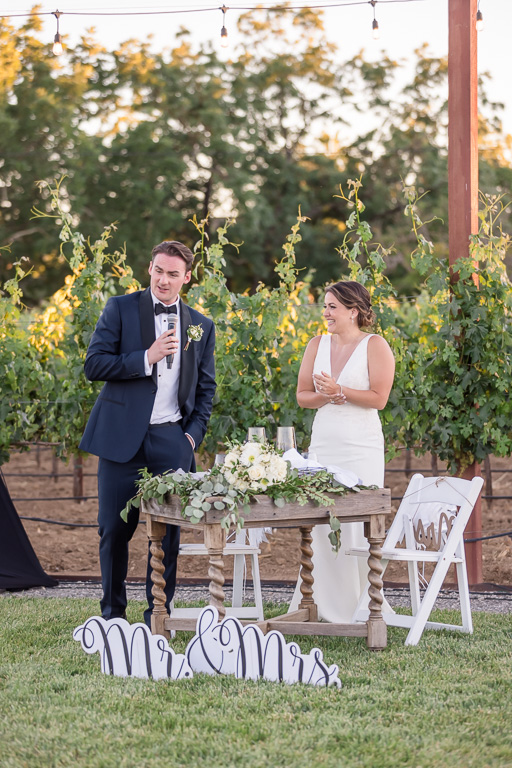 bride and groom thank-you toast in vineyard