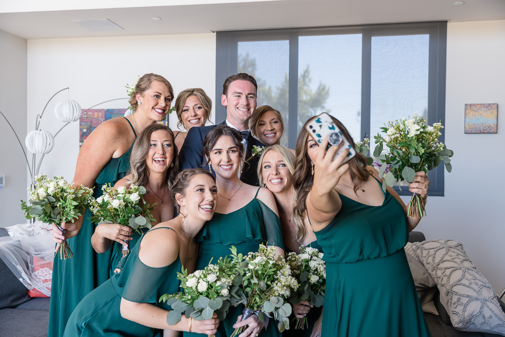 bride taking selfie with bridesmaids