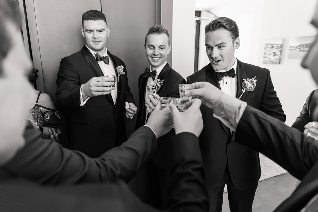 groom and the boys taking a shot of courage