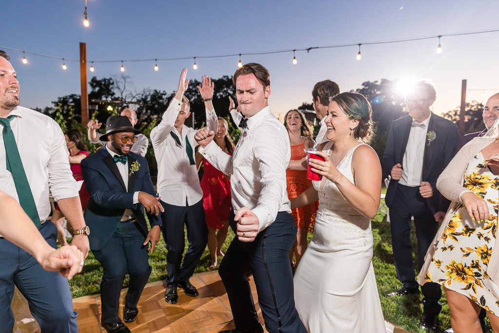 bride and groom having fun with their guests