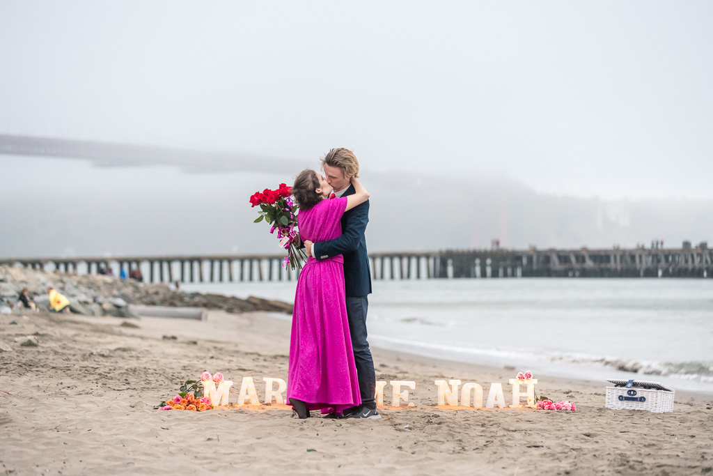 hugging after proposal on Crissy Field beach