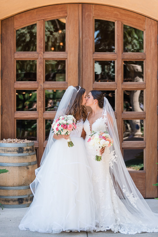 photo of the two brides in front of Trentadue Winery door