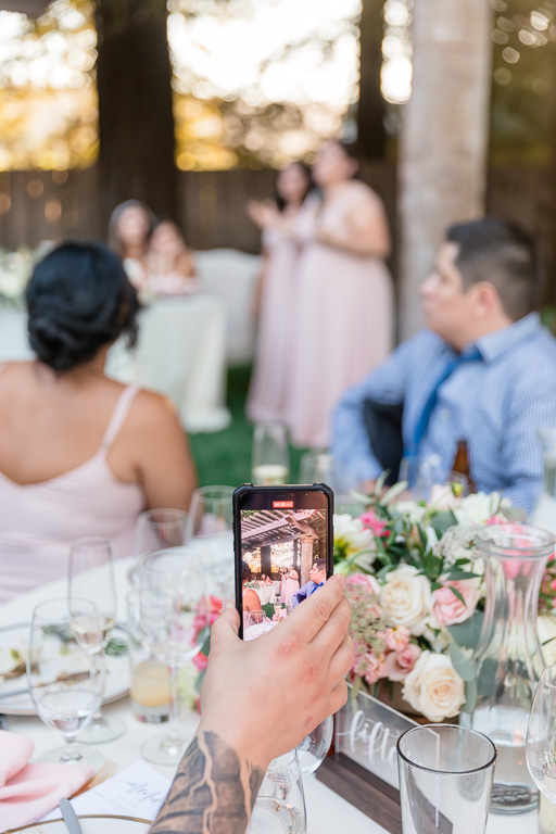 wedding guest taking a video on their phone