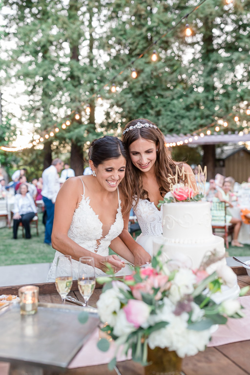 brides cutting their wedding cake