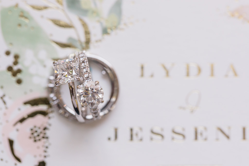 pair of diamond engagement rings on wedding invitations