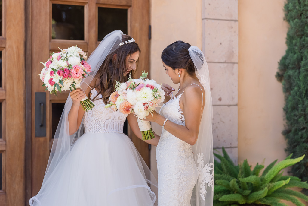 brides admiring each other's wedding dress during first look