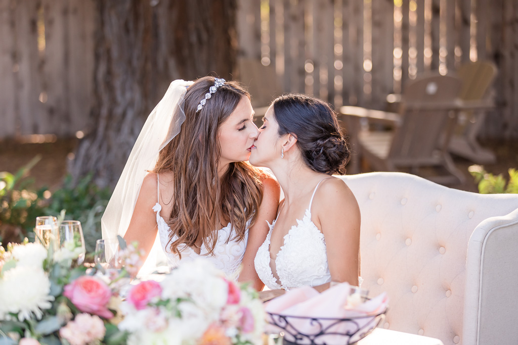 photo of the brides kissing during reception