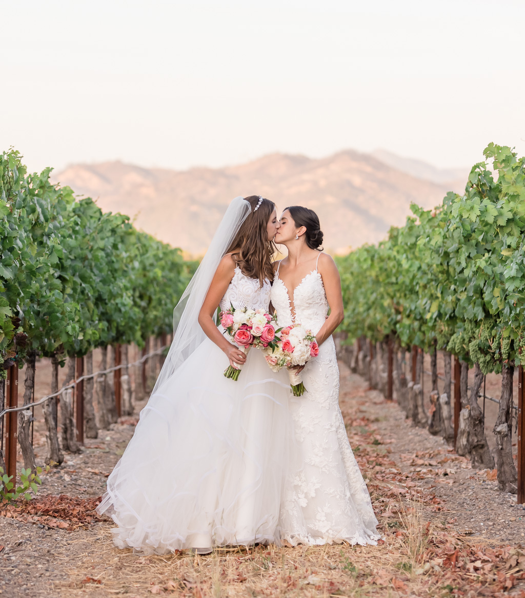 bride and bride kissing sunset photo at Trentadue Winery