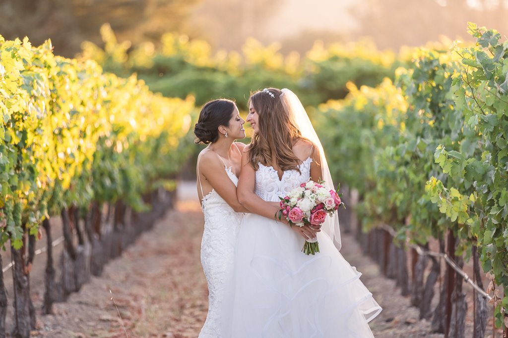 cute snuggly wedding photo of the brides in the Trentadue Winery vineyards
