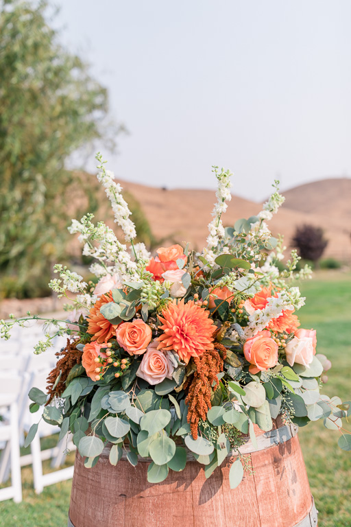 orange pastel wedding ceremony floral piece