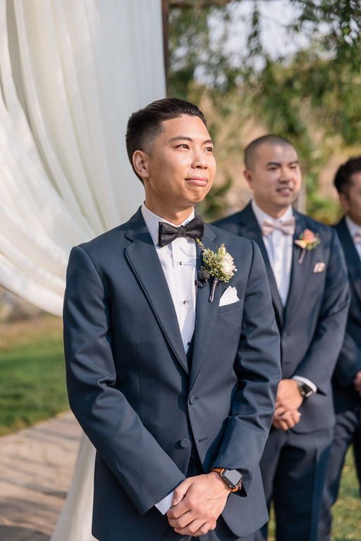 groom anxiously waiting for his bride to walk down the aisle