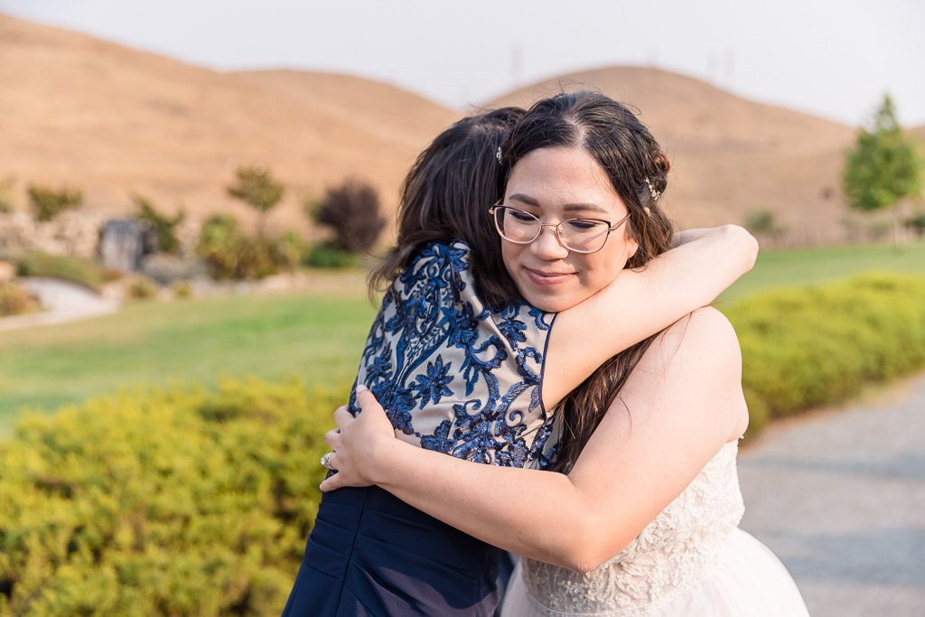 bride and mom hugging