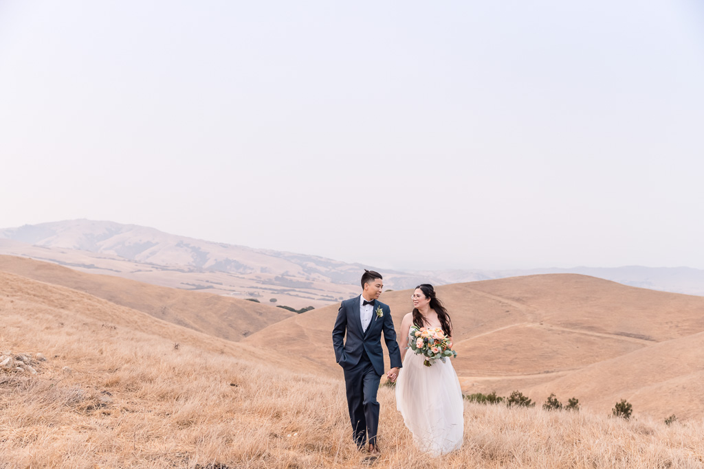 bride and groom on the rolling hills in Sunol during a hazy golden hour