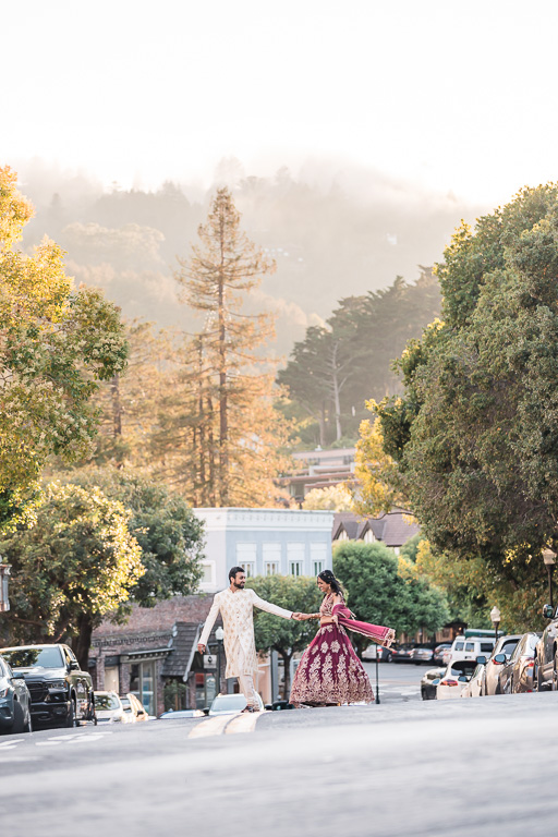 bride and groom crossing the street in Mill Valley at sunset