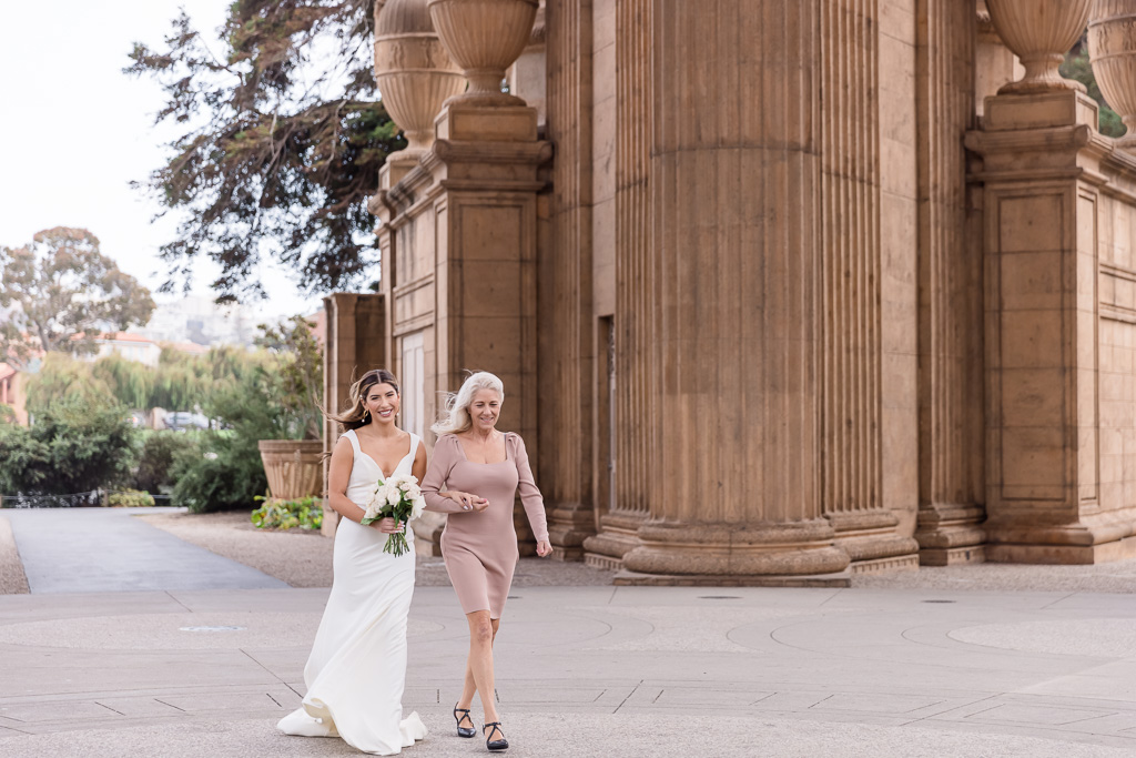 mom walking bride down the aisle at the Palace of Fine Arts