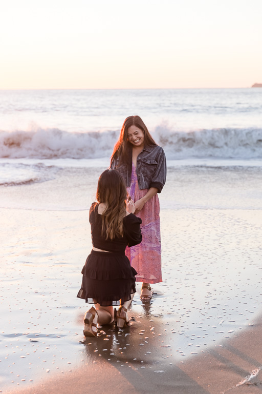 Baker Beach sunset surprise proposal in front of ocean waves