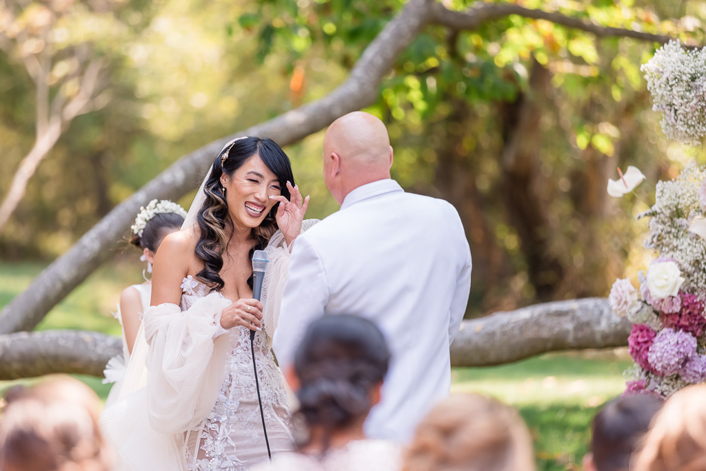 bride wiping away her happy tears when exchanging vows