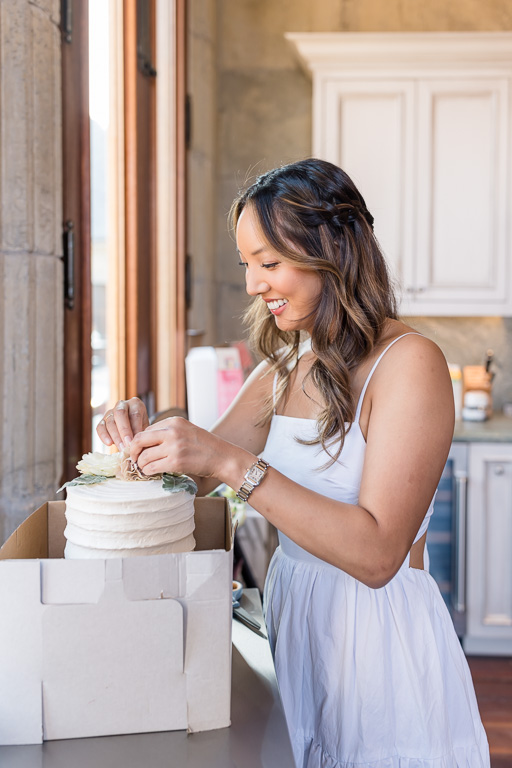 bride preparing her wedding cake