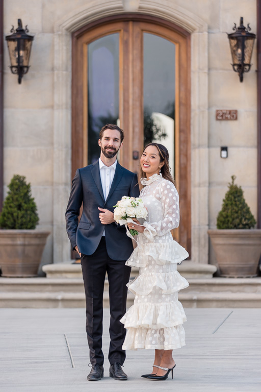 elegant bride and groom in front of European-inspired doors
