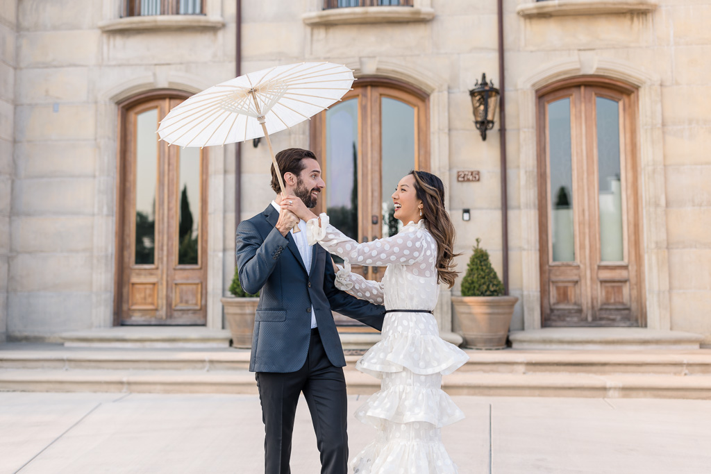 bride and groom with a parasol