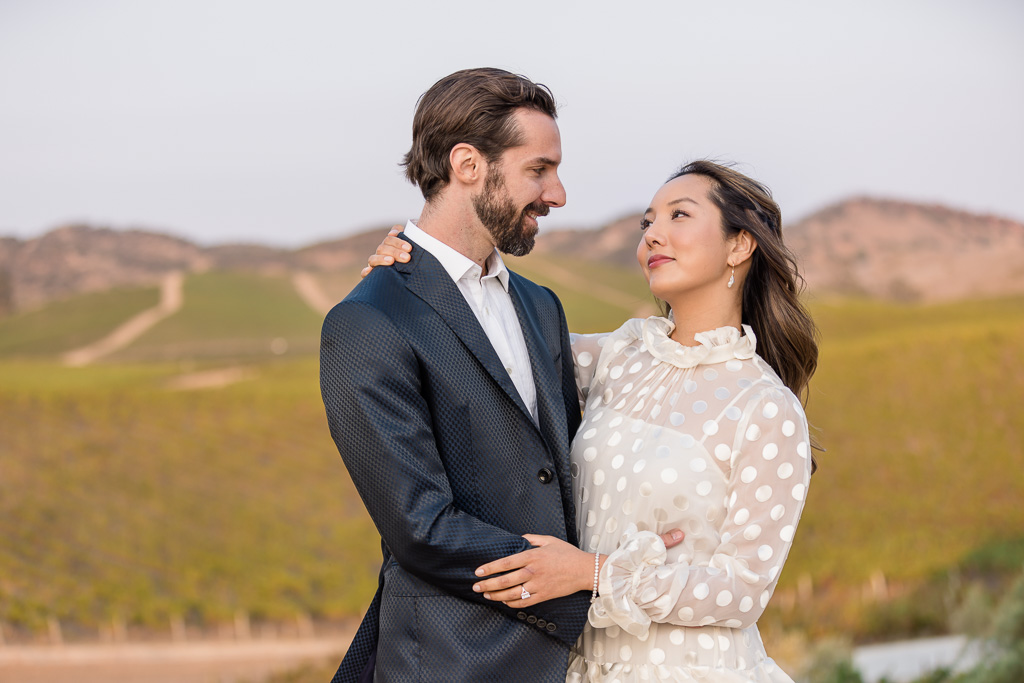wedding portraits atop Sonoma hill overlooking vineyards