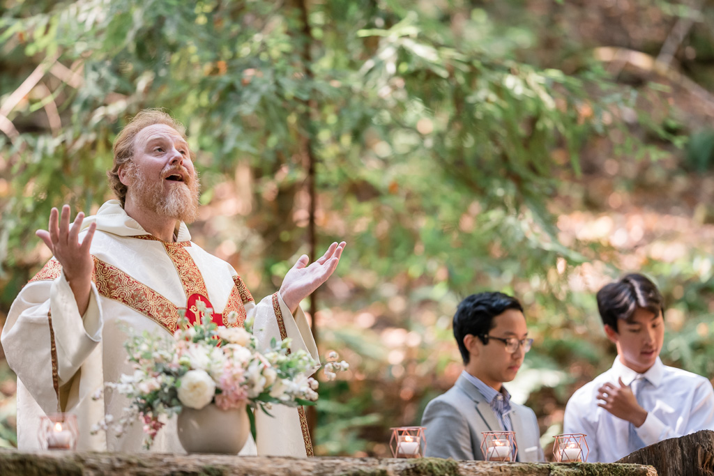 priest performing an outdoor wedding ceremony