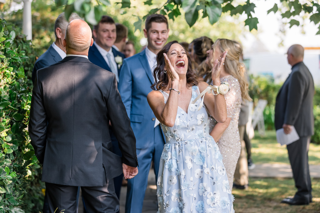 mother of the groom laughing hysterically at something