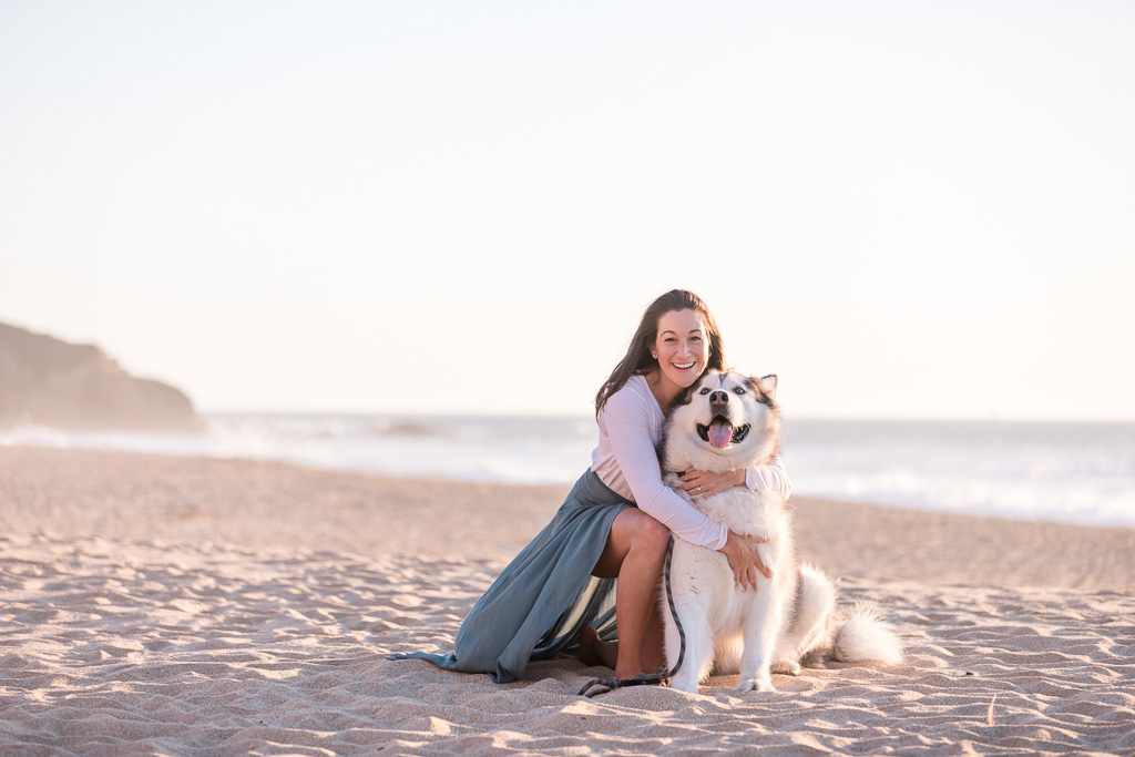 girl with a big malamute on the beach