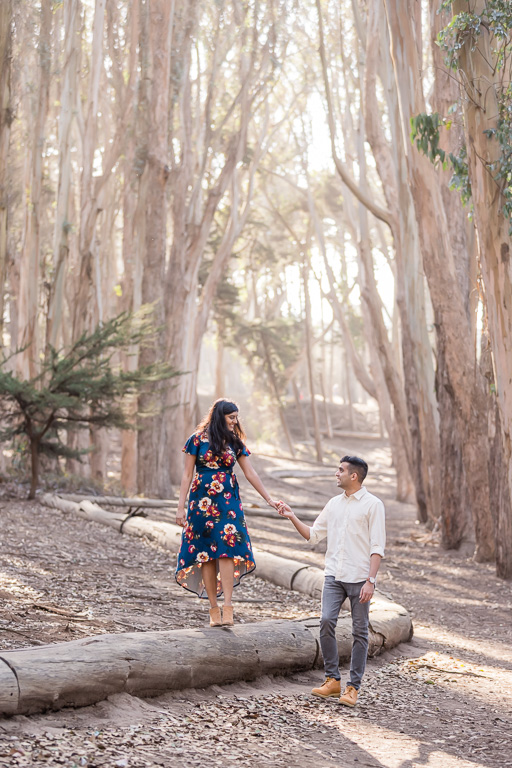 Lovers’ Lane walking on log engagement photo