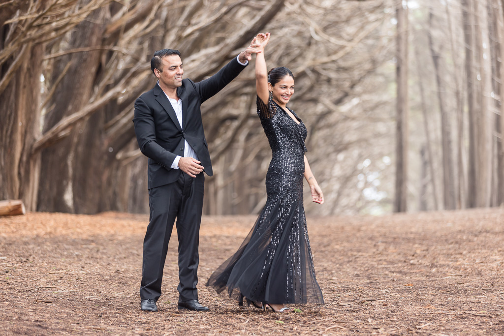 engagement photos under cypress trees in black tux and black sequin dress