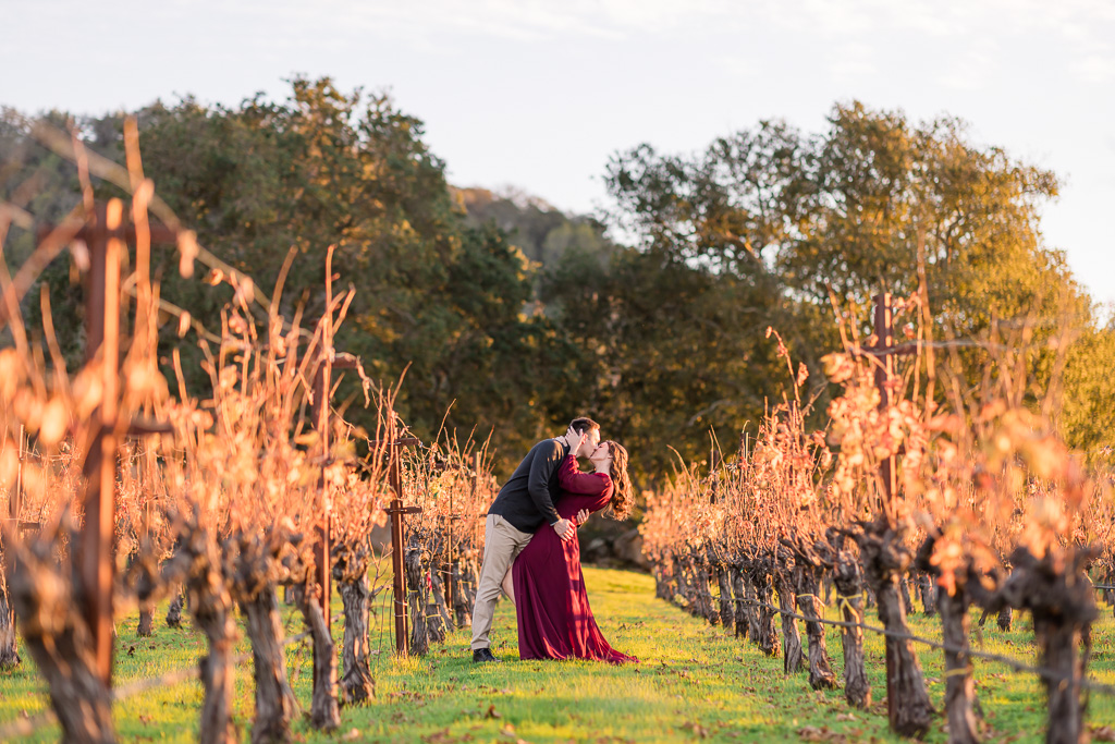 fall engagement photos at vineyard in St Helena in burgundy dress