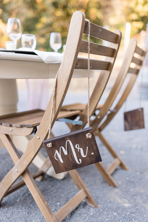 wooden Mr and Mrs signs on head table chairs