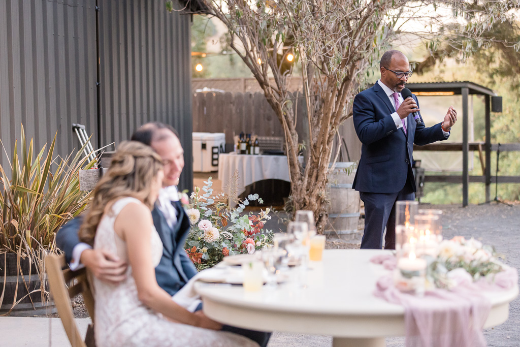 reverend giving toast at wedding reception