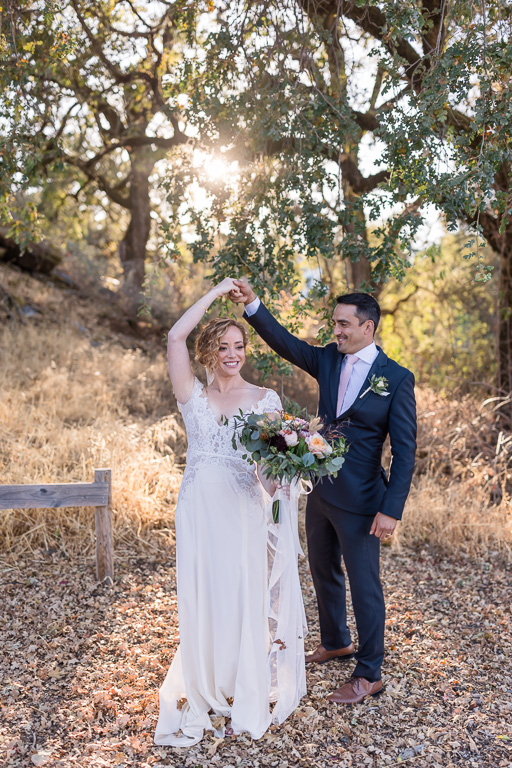 bride and groom twirl photo