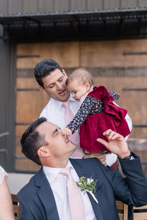 baby honking the groom’s nose