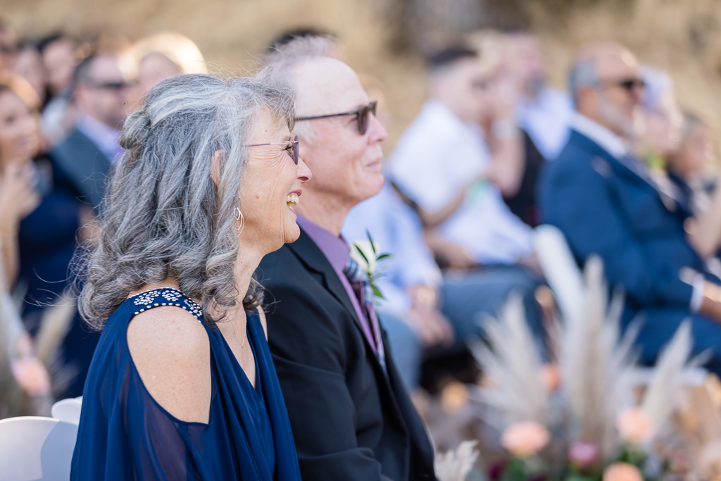 parents of the bride at the ceremony looking at the couple